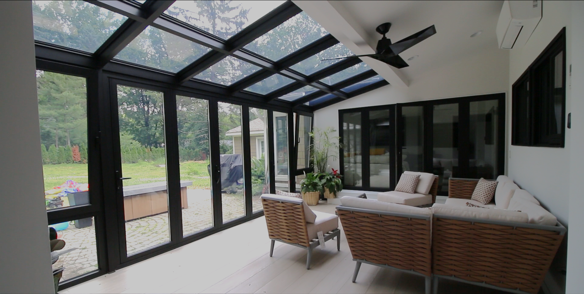 Four season sun room in Michigan installed with glass door walls and glass windows, for a glass wall & abundant sunlight