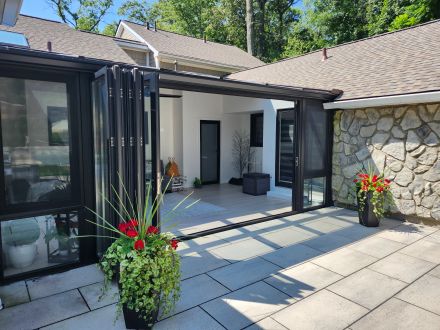 Wood interior, durable metal clad exterior folding glass doors make a vast difference in appearance and function in MI