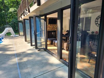 Slim sightlines and large openings are some of the advantages of accordion style glass door walls or bifold windows.